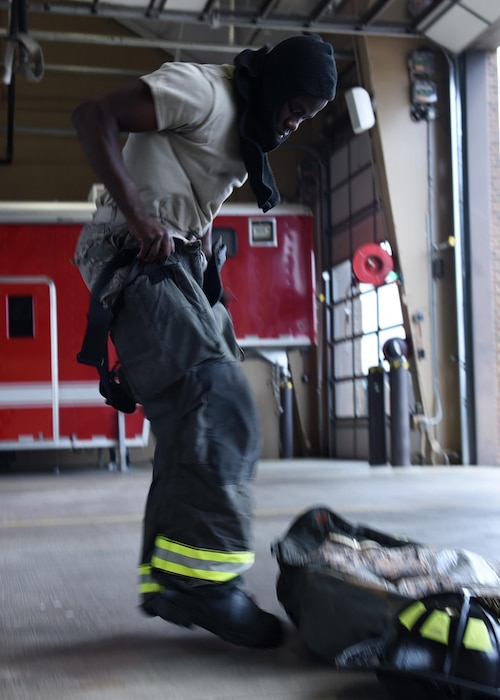 Airman 1st Class Tevado Beckford, 19th Civil Engineer Squadron Fire Protection apprentice, dons his fire gear in 39 seconds June 13, 2017, at Little Rock Air Force Base, Ark. The 19th CES Fire Department firefighters respond to fires or emergency situations on base at a moment’s notice. (U.S. Air Force photo by Airman 1st Class Kevin Sommer Giron)