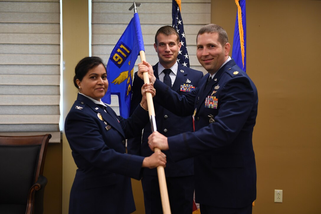 Col. Beena Maharaj, commander of the 911th Mission Support Group, passes command of the 911th Security Forces Squadron to Maj. Jason Price during an assumption of command ceremony at the Pittsburgh International Airport Air Reserve Station, Pa., June 3, 2017. Prior to his new position at Pittsburgh ARS, Maj Price was stationed at the Pentagon where he was assigned to the Headquarters Air Force Staff and served as the Chief of the Mobilization Branch, working for the Directorate of Current Operations. (U.S. Air Force photo by Senior Airman Beth Kobily)