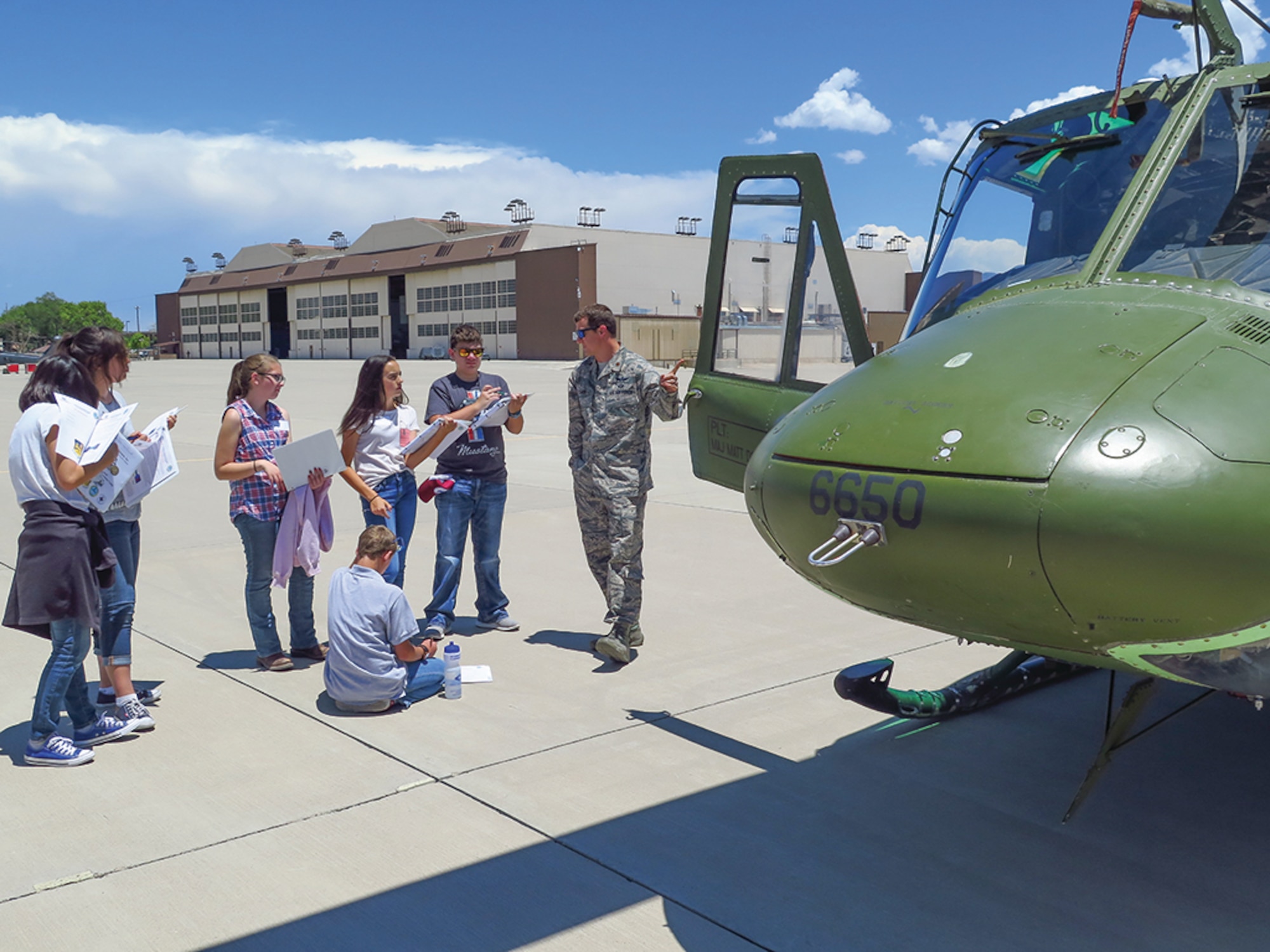 Tuskegee Airmen Inc. Youth Aviation Camp participants get an up-close look at Huey with Maj. Frank Cumbie on the 58th Special Operations Wing flightline.