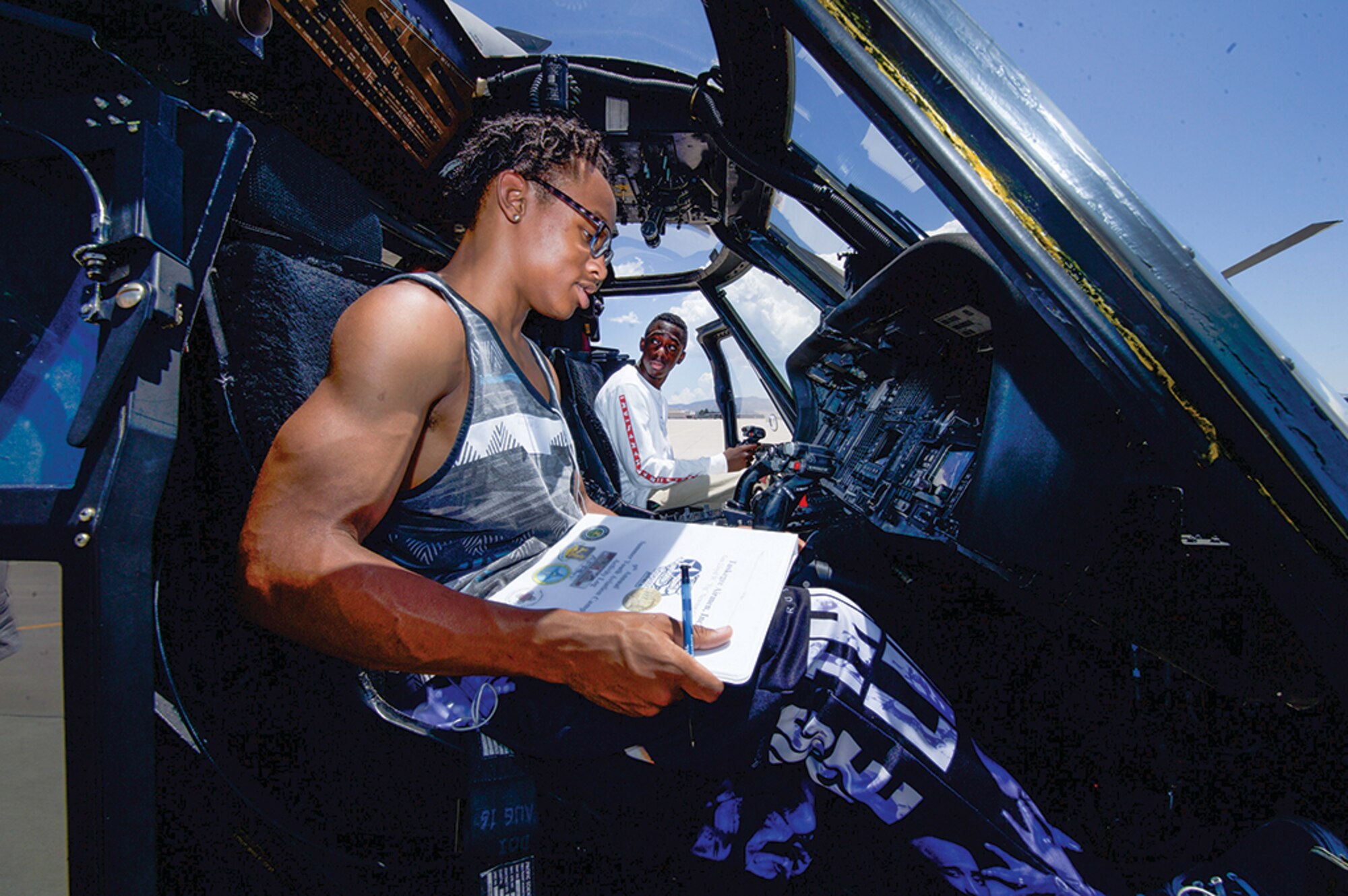 Tuskegee Airmen Inc. Youth Aviation Camp participants Manuel Johnson and Tolu Erinle check out the cockpit of an aircraft on the 58th Operations Wing flightline.