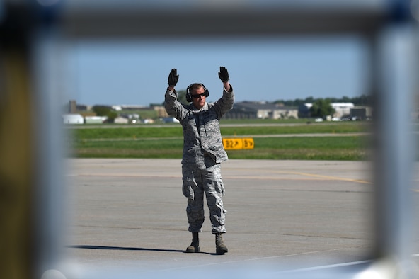 Staff Sgt. John Costello, 132d Wing transient alert, signals to an F-16 on the ramp May 24, 2017 at the 114th Fighter Wing, Sioux Falls, South Dakota. Transient alert volunteers recived refresher training to remain mission qualified. (U.S. Air National Guard photo by Senior Master Sgt. Robert P. Shepherd)
