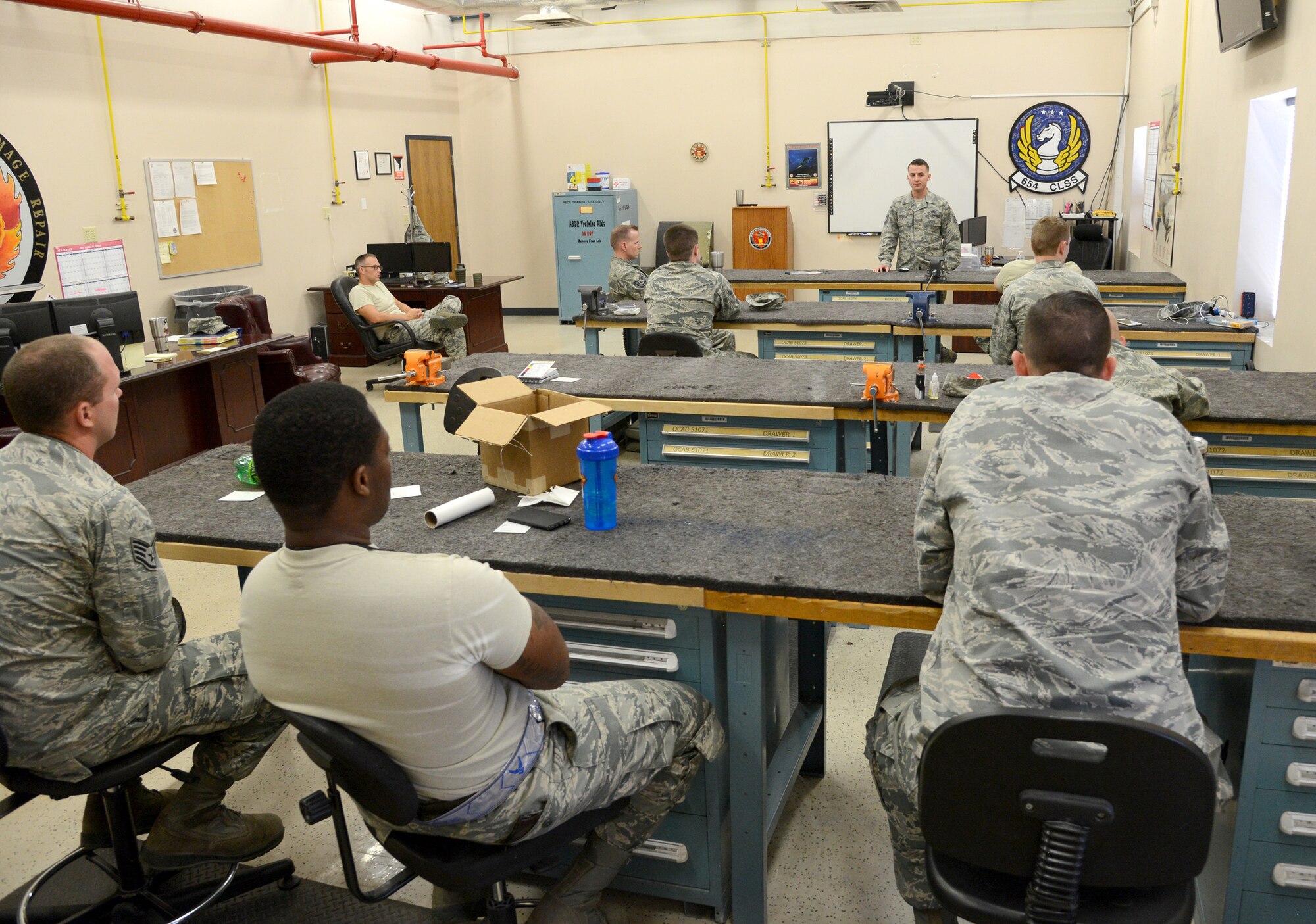 Tech. Sgt. Kyle Schultz, aircraft battle damage repair instructor with the 76th AMXG’s Expeditionary Depot Maintenance Flight, leads a self-aid buddy care briefing before the main portion of their exercise kicked off. (Air Force photo by Kelly White)