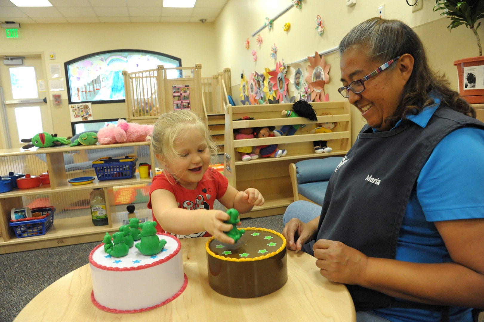 Maria Lopez, Child Development Center, child and youth program assistant, teaches Naomi Burton about colors and numbers, June 19, at Joint Base San Antonio-Randolph.  The CDP welcomes children between the ages of 6 weeks and 5 years. The CDP provides activities and programs which support children’s social, emotional, physical and intellectual development. The program is accredited by National Association for the Education of Young Children (NAEYC). The CDP is a USDA certified center, providing breakfast, lunch and two snacks each day.