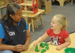 Maria Lopez, Child Development Center, child and youth program assistant, teaches Naomi Burton about colors and numbers, June 19, at Joint Base San Antonio-Randolph.  The CDP welcomes children between the ages of 6 weeks and 5 years. The CDP provides activities and programs which support children’s social, emotional, physical and intellectual development. The program is accredited by National Association for the Education of Young Children (NAEYC). The CDP is a USDA certified center, providing breakfast, lunch and two snacks each day.
