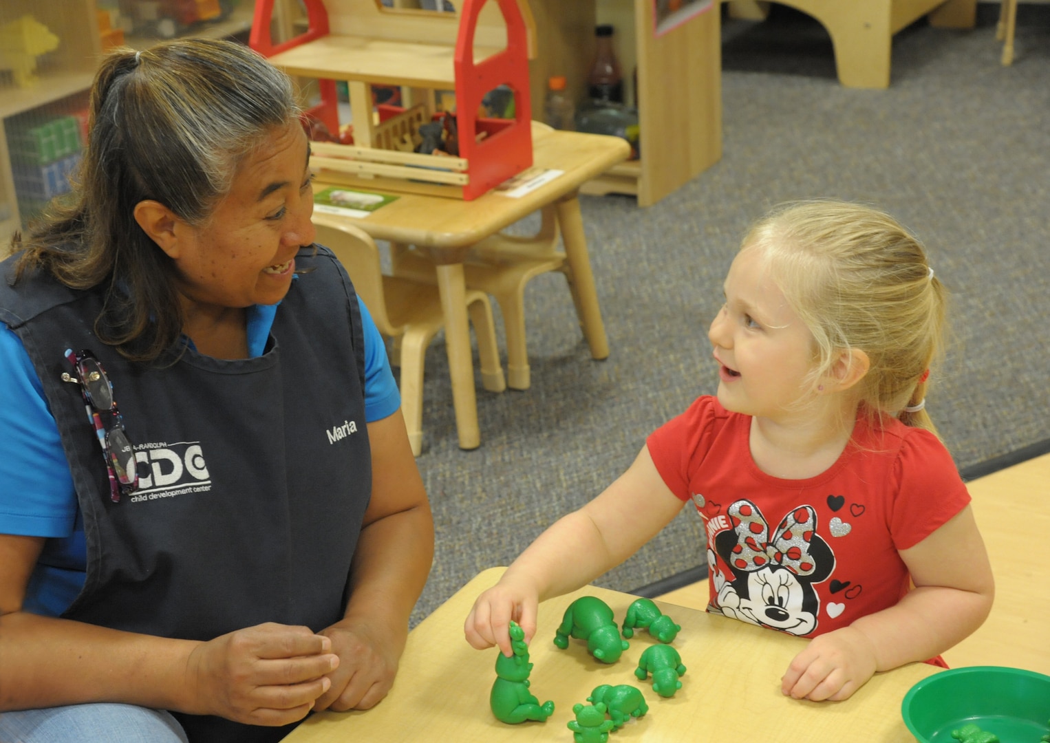 Maria Lopez, Child Development Center, child and youth program assistant, teaches Naomi Burton about colors and numbers, June 19, at Joint Base San Antonio-Randolph.  The CDP welcomes children between the ages of 6 weeks and 5 years. The CDP provides activities and programs which support children’s social, emotional, physical and intellectual development. The program is accredited by National Association for the Education of Young Children (NAEYC). The CDP is a USDA certified center, providing breakfast, lunch and two snacks each day.