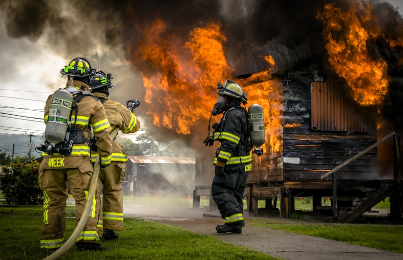 Lead firefighter, Master Sgt. Corey T. Coleman instructs and manages the team to ensure the training runs smoothly. The 612th Air Base Squadron Fire Department host a public fire training at Soto Cano Air Base, June 16, 2017. (U.S. Air Force photo by Senior Airman Julie Kae/released)