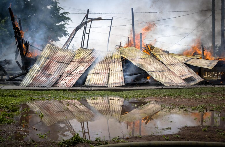 The hooch begins to crumble as it burns down. The 612th Air Base Squadron Fire Department host a public fire training at Soto Cano Air Base, June 16, 2017. 