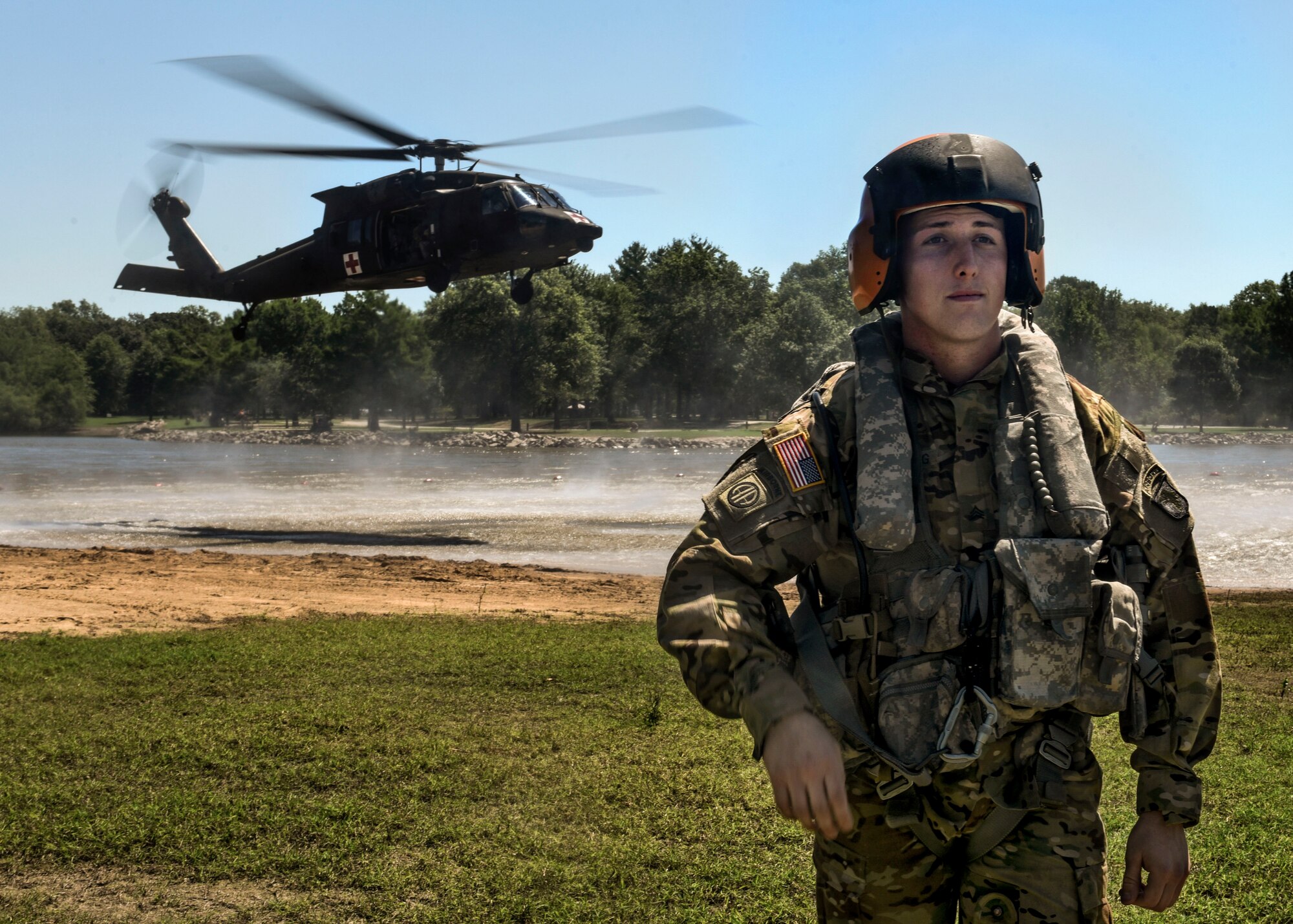 A U.S. Army member of the 6-101st Aviation Regiment from Fort Campbell, Ky. prepares for their unit's first-ever medical evacuation water extraction with Survive, Evade, Resist, and Escape instructors from Scott Air Force Base at Lake Carlyle, Ill., June 7, 2017. Lt. Col. Brooke Matson, 375th Operations Support Squadron, Lt. Col. Brandon Dow, 54th Airlift Squadron, and Maj. Madison Basil Jr., Headquarters Air Mobility Command, received hoist, water survival, and flare training to learn how to survive in aquatic situations long enough to be rescued. The 101st Combat Aviation Brigade has served in almost every single military operation since the Vietnam War, including combat, peacekeeping, and humanitarian.  By partnering with Air Mobility Command’s SERE instructors, this training allows for joint-service coordination while preparing aerial crew members to survive in austere locations after being displaced from their aircraft.  (U.S. Air Force photo by Staff Sgt. Jodi Martinez)