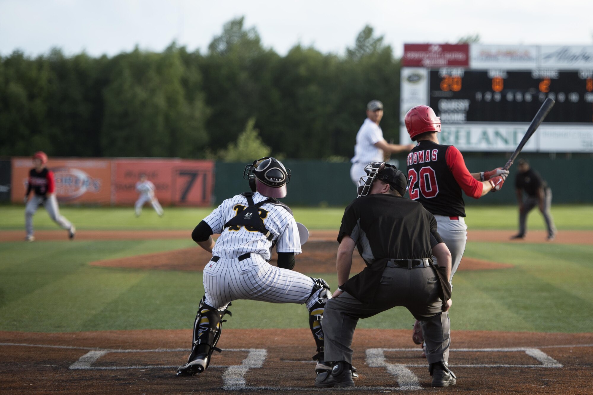 John Tomas, Peninsula Oilers player knocks a baseball down left field at Mulcahy Stadium in Anchorage, Alaska, June 16, 2017. The Anchorage Bucs faced off against the Peninsula Oilers for a doubleheader as part of a military appreciation event. 