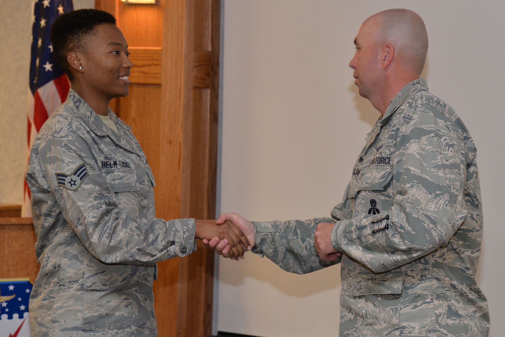Senior Airman Jasmine Helm-Lucas, 341st Munitions Squadron munitions controller, is recognized by Col. Ron Allen, 341st Missile Wing commander, June 7, 2017, at Malmstrom Air Force Base, Mont. Helm-Lucas was recognized for sharing her personal story with members of the base. (U.S. Air Force photo/Airman 1st Class Daniel Brosam)
