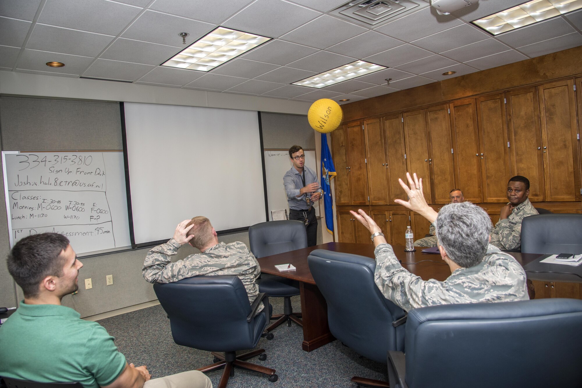 Josh Hale, 42nd Force Support Squadron personal trainer, tosses around a kickball during the questions and answers portion of the nutrition and fitness brief, June 20, 2017, Maxwell Air Force Base, Ala. Hale tested the attendees’ knowledge on fitness and explained what should be included in an ideal workout routine. (U.S. Air Force photo/ Senior Airman Alexa Culbert)