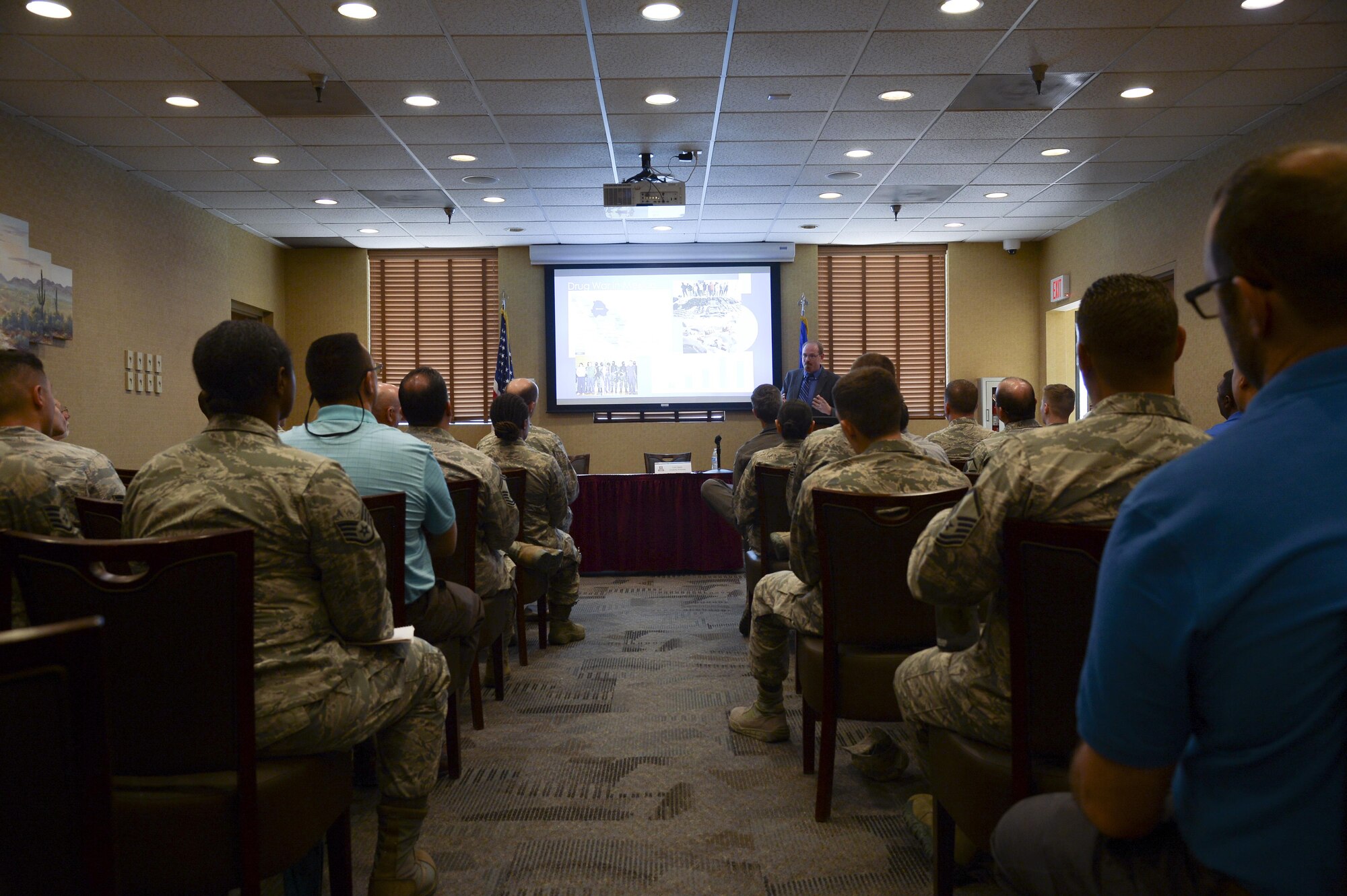 Members of 12th Air Force (Air Forces Southern) and University of Arizona listen as Colin Deeds, University of Arizona Latin American Studies Center assistant director, lectures during a speaker series event at Davis-Monthan Air Force Base, Ariz., June 19, 2017, for the 12th Air Force (Air Forces Southern) Academic Outreach Program with the University of Arizona. The intent of the speaker series is to facilitate the exchange ideas between government and academic institutions while fostering collaborative discussions about global issues. (U.S. Air Force photo by Staff Sgt. Angela Ruiz)