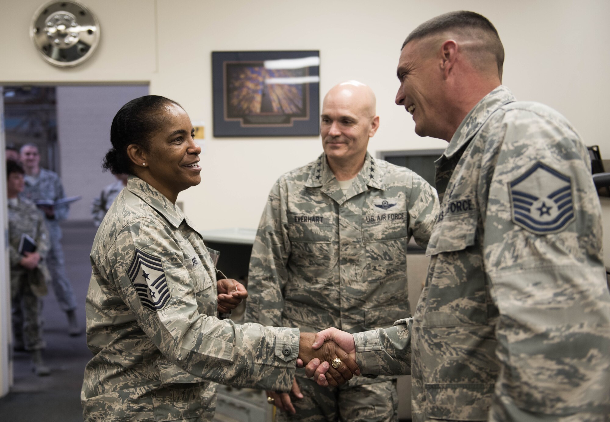Gen. Carlton D. Everhart II, Air Mobility Command commander, and Chief Master Sgt. Shelina Frey, AMC command chief, recognize Master Sgt. Gavin Douglas, 92nd Maintenance Group quality assurance, for his service during their tour to the 92nd MXG June 20, 2017, at Fairchild Air Force Base, Washington. Everhart and Frey engaged Airmen across the base to get a first-hand look at how the units at Fairchild strive to provide first-class operations. (U.S. Air Force photo/Senior Airman Sean Campbell)