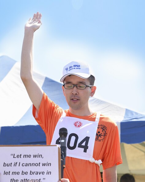 A competitor reads the Special Olympics athletes oath at the 38th Annual Kanto Plains Special Olympics opening ceremony at Yokota Air Base, Japan, June 17, 2017. The Special Olympics provides people with intellectual disabilities continuing opportunities to realize their potential, develop physical fitness, demonstrate courage, experience joy and friendship. (U.S. Air Force photo by Machiko Arita)