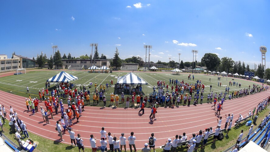 Volunteers cheer on runners during the 50 meters sprint at Yokota Air Base, Japan, June 17, 2017. Approximately 1000 volunteers from United States Armed Forces, Japan Self-DefenseForces and local communities took part in the event and cheered on athletes. (U.S. Air Force photo by Machiko Arita)
