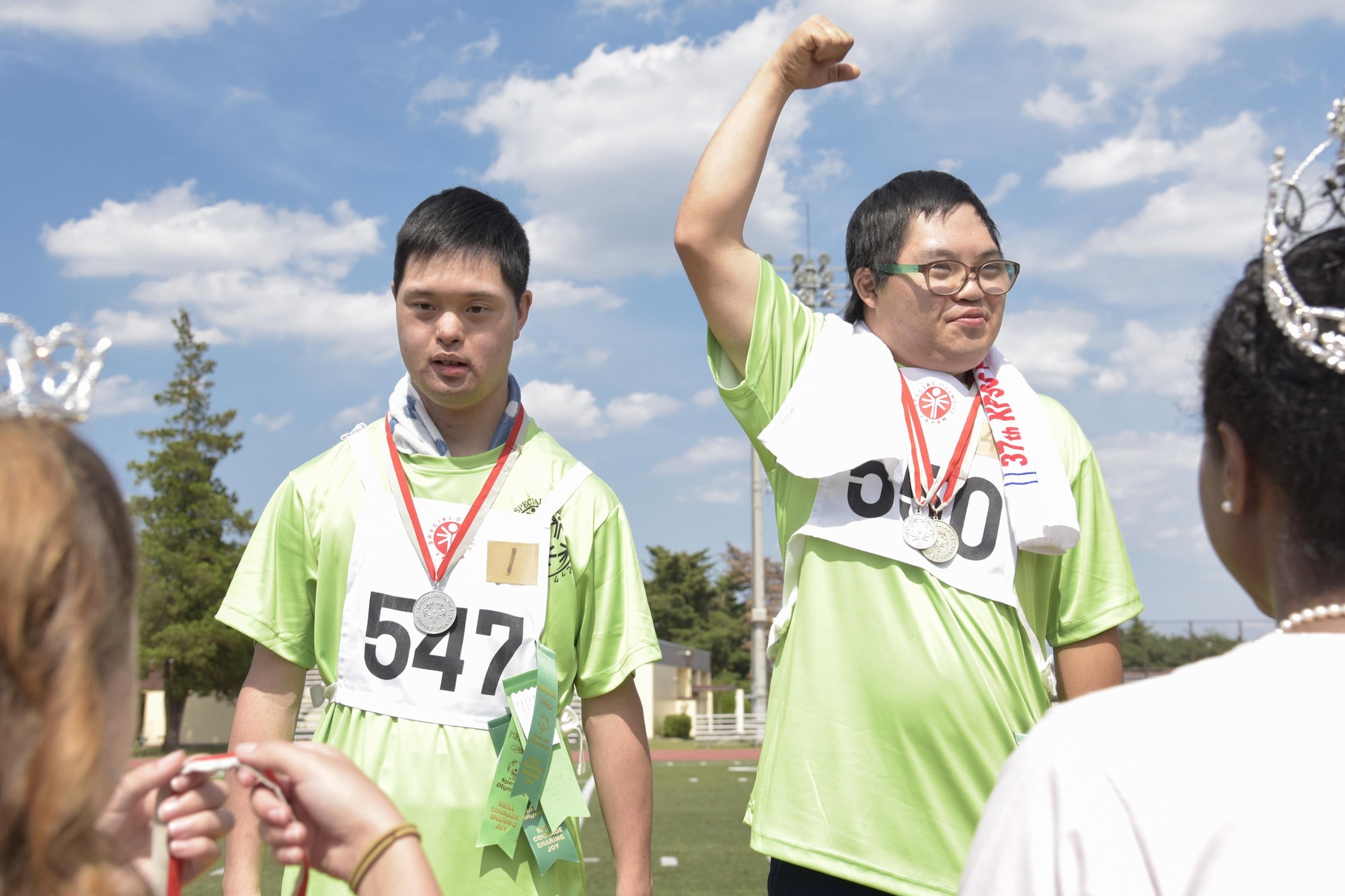 An athlete celebrates after receiving his medal in the standing long jump competition during the 38th Annual Kanto Plains Special Olympics at Yokota Air Base, Japan, June 17, 2017. The Special Olympics provides people with intellectual disabilities continuing opportunities to realize their potential, develop physical fitness, demonstrate courage, experience joy and friendship. (U.S. Air Force photo by Machiko Arita)