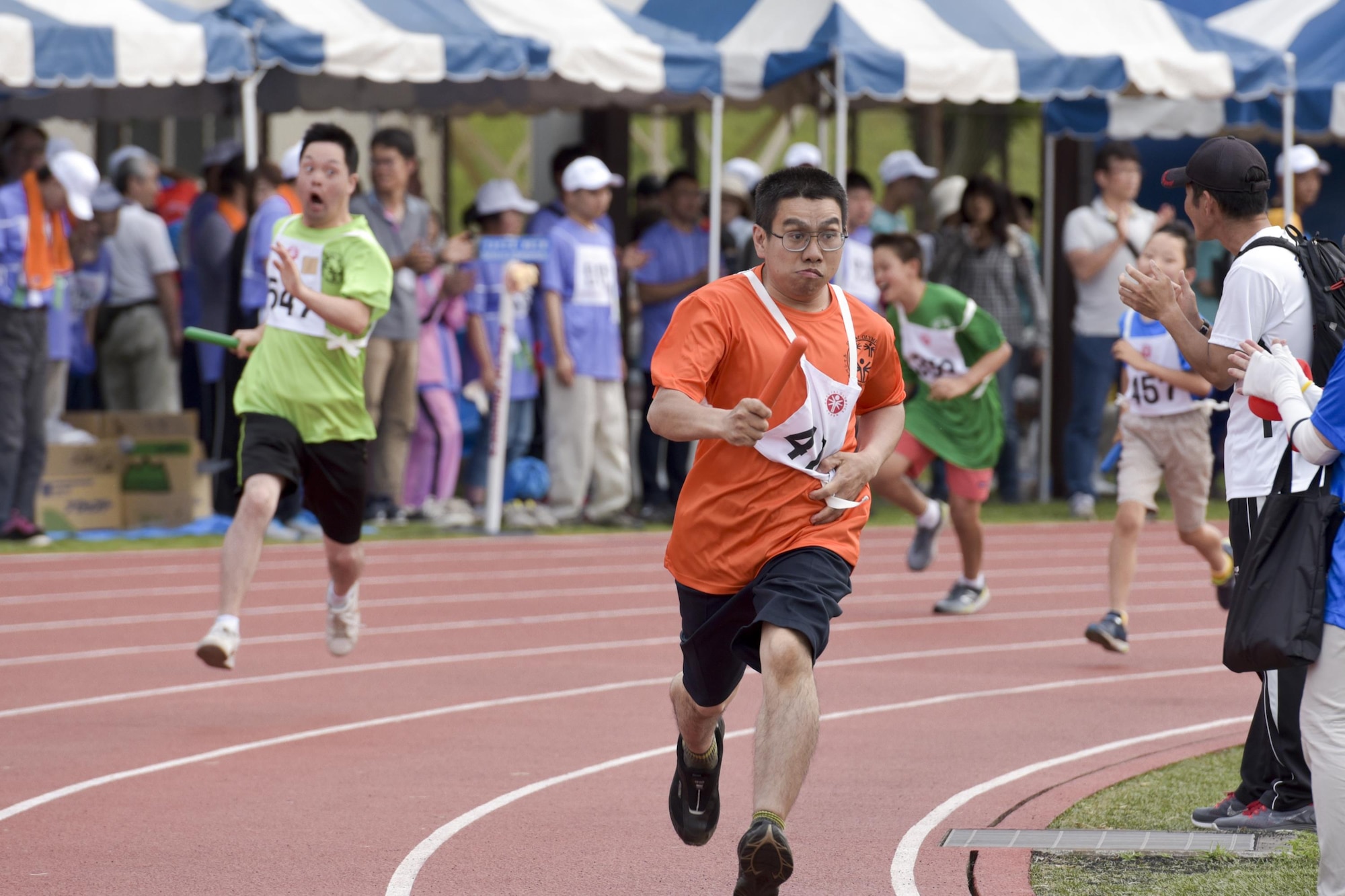 Athletes run in the 400 meters relay during the 38th Annual Kanto Plains Special Olympics at Yokota Air Base, Japan, June 17, 2017. 127 athletes from eight local schools and the
Department of Defense Education Activity throughout the Kanto Plain region competed in various sports ranging from the track and field and bowling to basketball and swimming.  (U.S. Air Force photo by Machiko Arita)