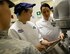 U.S. Air Force Senior Master Sgt. Teresa Vanderford, Air Force General Officer Management Office enlisted aide program manager, right, checks on the batter made by Airman 1st Class Jessica Raterman, 100th Force Support Squadron food service apprentice at the Gateway Dining Facility on RAF Mildenhall, England, June 8, 2017. During the weeklong culinary seminar, each day was dedicated to different foods and techniques, such as baking, Latin American Food, and knife skills. (U.S. Air Force photo by Senior Airman Justine Rho) 