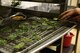 An Airman checks on candied mint leaves made during culinary training at the Gateway Dining Facility on RAF Mildenhall, England, June 8, 2017. Part of the weeklong training focused on encouraging creativity within the 100th Force Support Squadron members. Though cooks are required to follow a set menu, but they can add finesse and technique to food preparation. (U.S. Air Force photo by Senior Airman Justine Rho) 
