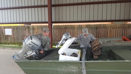 Louisiana National Guard Cadet Hunter Fontenot and Spc. Jason Albritton, of 769th Brigade Engineer Battalion, 256th Infantry Brigade Combat Team, inspect boats ahead of the possible response to Tropical Storm Cindy. More than 80 high-water vehicles and 33 boats have been staged in 14 parishes. 