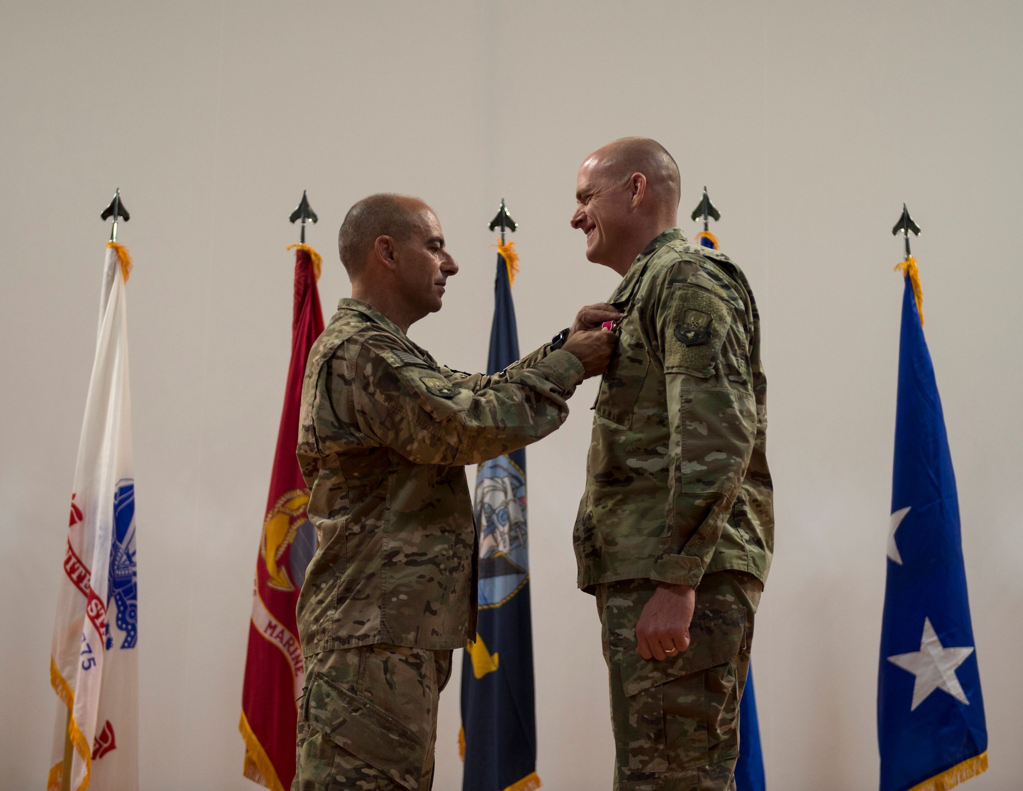 U.S. Air Force Lt. Gen. Jeffrey L. Harrigian, commander of the U.S. Air Forces Central Command, pins the Legion of Merit Medal onto Brig. Gen. Darren V. James, commander of the 379th Air Expeditionary Wing, during the change of command ceremony at Al Udeid Air Base, Qatar, June 12, 2017. During his term, James’ leadership and vision guided the wing to produce 192,800 flight hours during 29,000 combat sorties, transport nearly 25,000 U.S. and coalition warfighters, deliver 915 million pounds of fuel, collect 9,200 hours of valuable intelligence, surveillance and reconnaissance, and deliver 10,500 precision-guided munitions.  (U.S. Air Force photo by Tech. Sgt. Amy M. Lovgren)