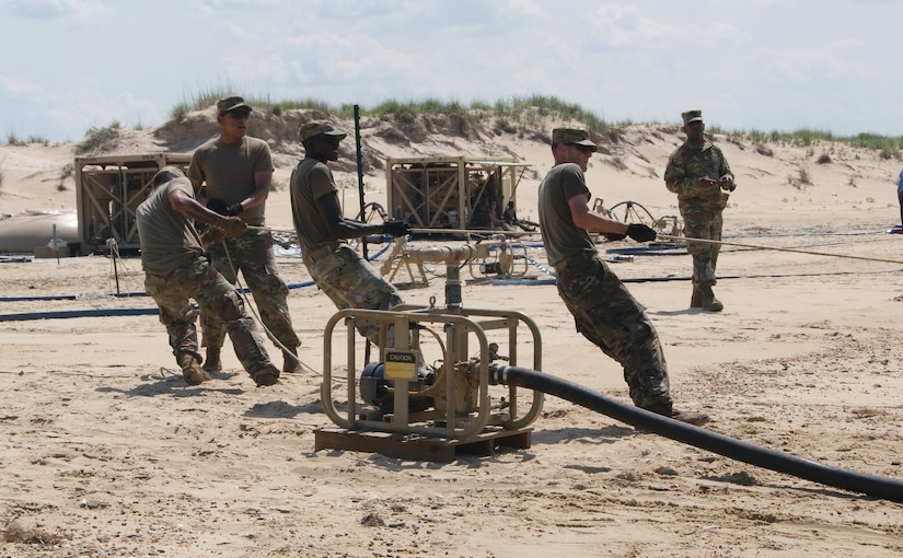 The water purification team from the 504th Composite Supply Company, out of Fort Bliss, Texas, tugs on the rope, preparing to capture salt water from the Atlantic Ocean during the Reverse Osmosis Water Purification Unit Rodeo at Fort Story, Virginia, June 12, 2017.