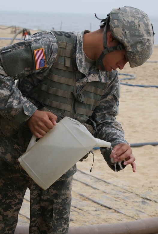 Sgt. Valentin Alvarez, a member of the 961st Quartermaster Company water purification team, tests the finished water product that his team purified during the Reverse Osmosis Water Purification Unit Rodeo at Fort Story, Virginia, June 15, 2017.