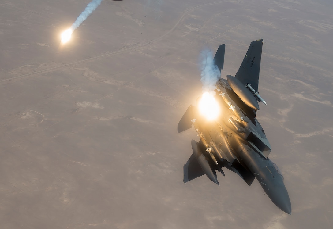 A U.S. Air Force F-15E Strike Eagle fires flares during a flight in support of Operation Inherent Resolve June 21, 2017. The F-15, a component of U.S. Air Forces Central Command, supports U.S. and coalition forces working to liberate territory and people under the control of ISIS. (U.S. Air Force photo by Staff Sgt. Trevor T. McBride)