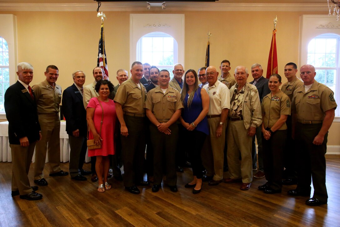 Members of the New Bern Military Alliance and Marine Corps Air Station Cherry Point senior leadership gathered during a during a luncheon in honor of the Military Family of the Quarter, Sgt. Shaun and Lindsay Monaghan, at the New Bern, N.C., Golf and Country Club, June 9, 2017. The Monaghan family received letters and certificates of appreciation, along with gifts as a thank you from community leaders. Monaghan is an intermediate level ordnance instructor at the Center for Naval Aviation Technical Training aboard MCAS Cherry Point, N.C. (Marine Corps photo by Cpl. Jason Jimenez/ Released)