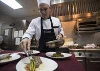 170616-N-ZV163-343 MANAMA, Bahrain (June 16, 2017) Culinary Specialist 2nd Class Michael Colburn, a sous chef trainee from Naples, Fla., plates his final dish inside the U.S. Naval Forces Central Command (NAVCENT) headquarters Flag Mess onboard Naval Support Activity Bahrain, June 16. Colburn passed the American Culinary Federation certification test to further his expertise in the culinary arts. This skill aids the NAVCENT commander with achieving objective and reaching common goals with leaders in the region by enabling them to sit down to a attractive and appealing meal. (U.S. Navy photo by Mass Communication Specialist 2nd Class Christina Brewer)