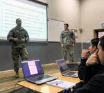 ROTC Cadet Nicholas Basel (left) from Purdue University and Cadet Gregory Long (right) from the University of Alabama give a presentation to Chilean Army Cadets during class at the Escuela Militar in Santiago, Chile. Thirty-two Reserve Officer Training Course cadets from various U.S. colleges attended the Cultural Understanding and Language Proficiency program in Santiago Chile from May 14 to June 2. The military-to-military exchange paired the U.S. cadets with Chilean cadets where they shared learning and cultural exchanges.