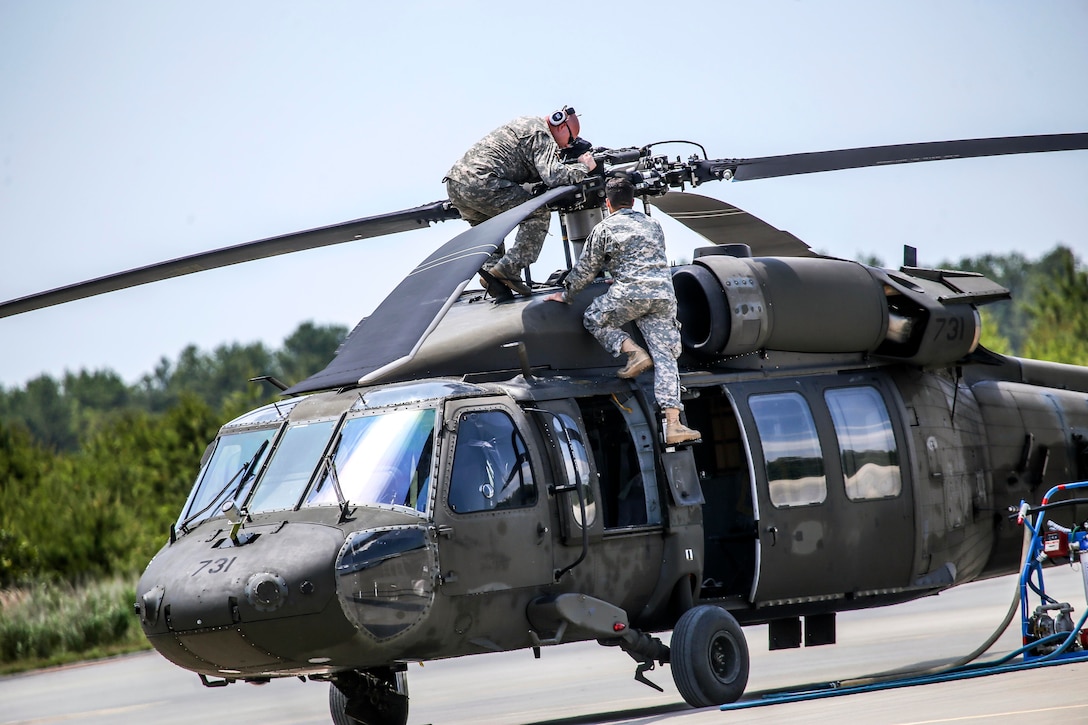 New Jersey Army National Guardsmen work on a UH-60 Black Hawk helicopter at Joint Base McGuire-Dix-Lakehurst, N.J., June 14, 2017. The soldiers are assigned to Delta Company, 1st Battalion, 150th Aviation Regiment. New Jersey Air National Guard photo by Master Sgt. Matt Hecht
