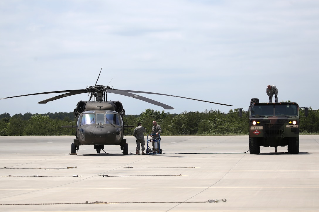 New Jersey Army National Guardsmen from Delta Company, 1st Battalion, 150th Aviation Regiment, refuel a UH-60 Black Hawk helicopter at Joint Base McGuire-Dix-Lakehurst, N.J., June 14, 2017. New Jersey Air National Guard photo by Master Sgt. Matt Hecht