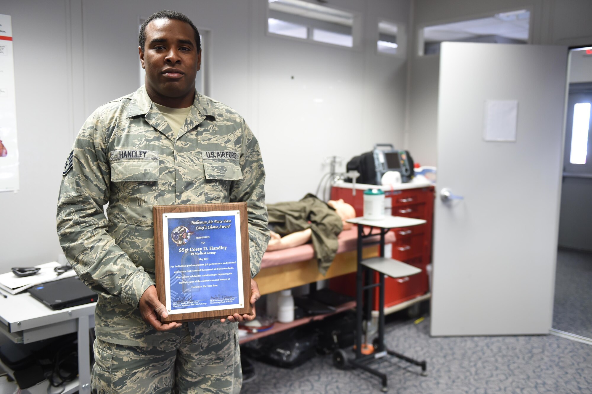 Staff Sgt. Corey D. Handley, 49th Medical Support Squadron radiology technician and acting Non-commissioned officer in charge of the 49th Medical Group education and training department, receives the May Chief’s Choice Award, May 17, 2017, at Holloman Air Force Base, N.M. (U.S. Air Force photo by Staff. Sgt. Stacy Jonsgaard)