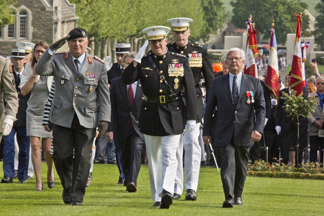 Guests of Honor attending a commemoration ceremony at the Aisne-Marne Cemetery walk across the center field near the woods of Belleau, France, May 28, 2017. The ceremony celebrated the Memorial Day holiday and commemorated the 99th anniversary of the beginning of the Battle of Belleau Wood. (U.S. Marine Corps photo by Lance Cpl. Hailey D. Clay)