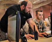 Rotem Guttman, a cyber security researcher for Carnegie Mellon University, gives instructions to U.S. Air National Guard Airman 1st Class William Wilson, currently assigned to the 112th Cyber Operations Squadron, out of Hirsham, Pennsylvania, on how to navigate a drone during a training exercise for the  Cyber X-Games, hosted by the Army Reserve Cyber Operations Group (ARCOG), 335th Signal Command (Theater), June 16 at Carnegie Mellon University. Cyber X Games is a five-day exercise focusing on advanced areas of cyber security training. Cyber X Games is also part of Cyber Endeavour, the Department of Defense-sponsored conference for military and civilian practitioners from across government, industry and academia to address the nexus of cyberspace and national security. (U.S. Army Reserve photo by 
Sgt. Erick Yates)