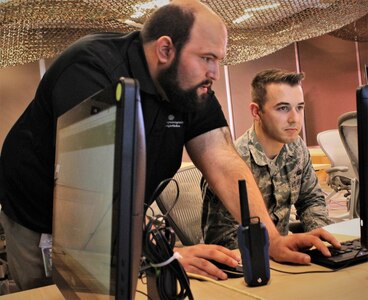 Rotem Guttman, a cyber security researcher for Carnegie Mellon University, gives instructions to U.S. Air National Guard Airman 1st Class William Wilson, currently assigned to the 112th Cyber Operations Squadron, out of Hirsham, Pennsylvania, on how to navigate a drone during a training exercise for the  Cyber X-Games, hosted by the Army Reserve Cyber Operations Group (ARCOG), 335th Signal Command (Theater), June 16 at Carnegie Mellon University. Cyber X Games is a five-day exercise focusing on advanced areas of cyber security training. Cyber X Games is also part of Cyber Endeavour, the Department of Defense-sponsored conference for military and civilian practitioners from across government, industry and academia to address the nexus of cyberspace and national security. (U.S. Army Reserve photo by 
Sgt. Erick Yates)