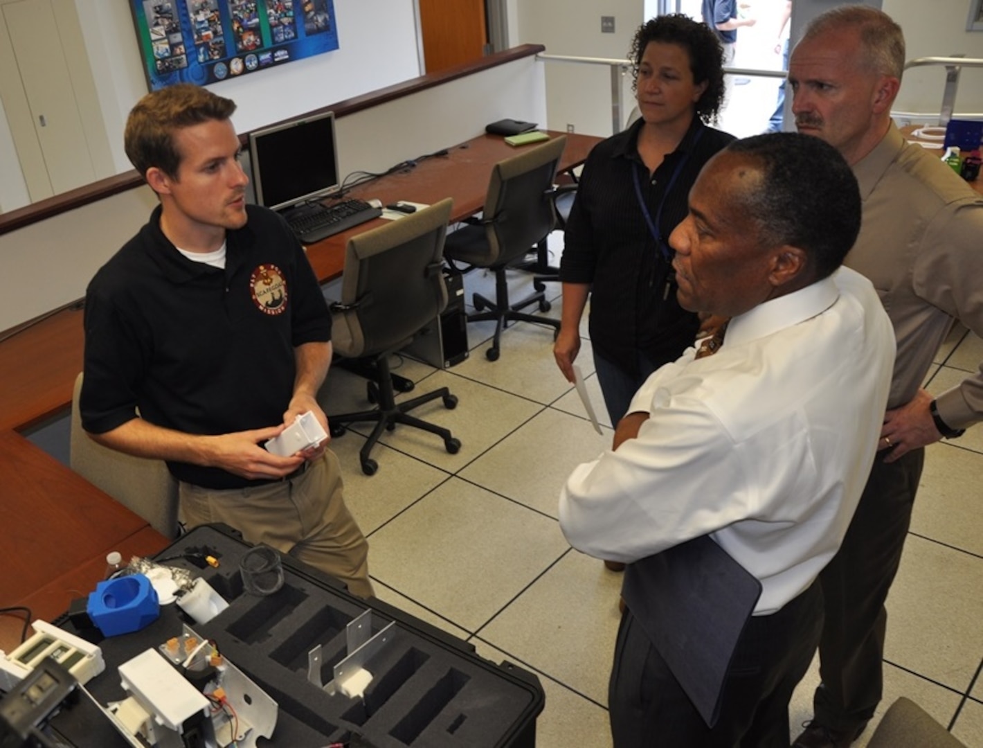 DAHLGREN, Va. (June 15, 2017) - Navy engineer Jonathan Crook briefs visitors about SCAPEGOAT chemical, biological, and radiological (CBR) detection system components during a demonstration. SCAPEGOAT was designed, prototyped, and tested over a six-month period by a team of junior scientists and engineers engaged in the Sly Fox Program at Naval Surface Warfare Center Dahlgren Division. With its relatively low cost and modular interfaces, the SCAPEGOAT system demonstrates the use of emerging technology in meeting warfighter needs.