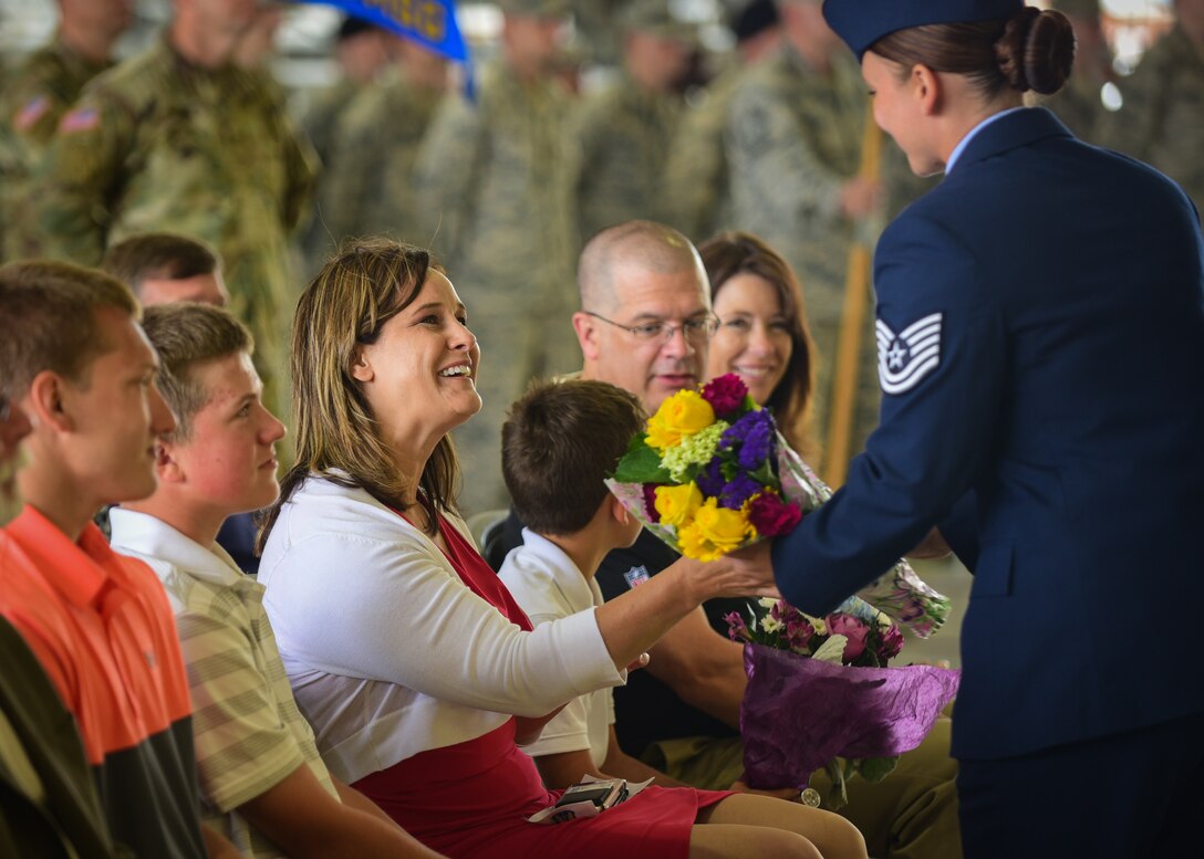 Sheri Tyler, wife of U.S. Air Force Col. Sean Tyler, 633rd Air Base Wing commander, receives a gift during the 633rd ABW change of command ceremony at Joint Base Langley-Eustis, Va., June 22, 2017. Tyler assumed command from U.S. Air Force Col. Caroline Miller and previously served at Langley in a variety of positions throughout his career, including as a flight commander, executive officer and deputy group commander. (U.S. Air Force photo/Staff Sgt. Areca T. Bell)