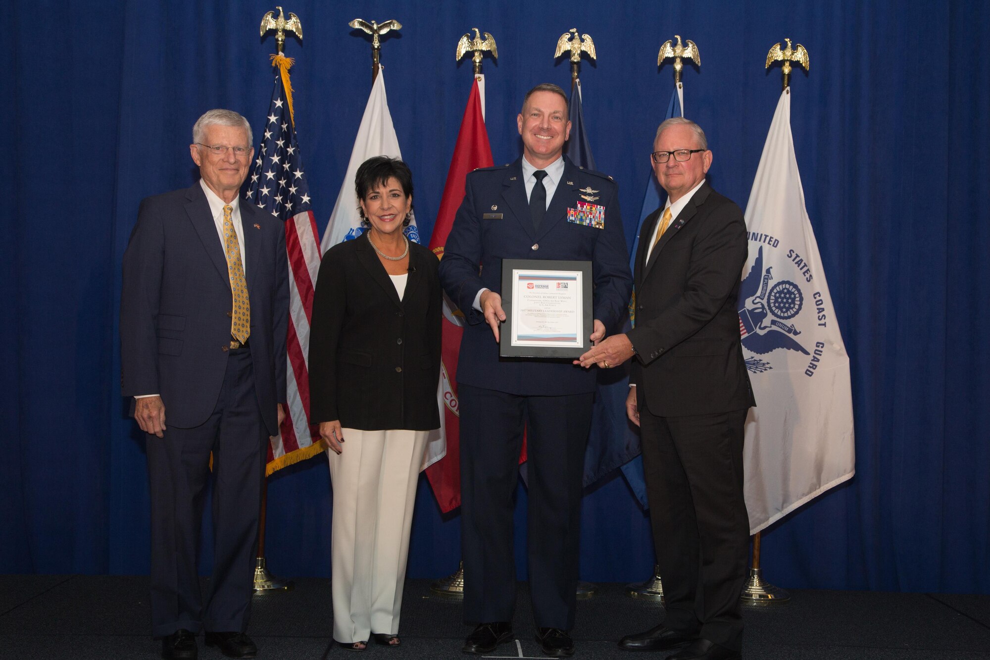 Bill Bethea (left), chair of the South Carolina Military Base Task Force, Celeste Werner (second from left), Association of Defense Communities board of directors awards committee liaison, and Michael Cooper (right), president, ADC, stand with Col. Robert Lyman, commander, 628th Air Base Wing, Joint Base Charleston, S.C following the 2017 Defense Communities National Summit. During the event Lyman was presented with the 2017 Military Leadership Award from the ADC for excellence in building and sustaining innovative community-military partnerships at Joint Base Charleston and for an active commitment to outreach with local and state stakeholders