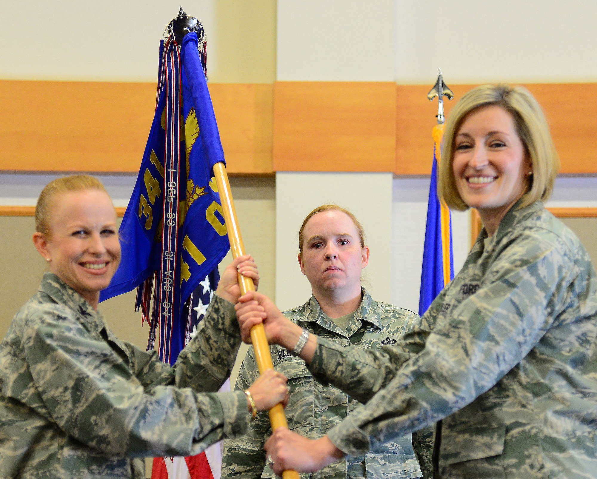 Lt. Col. Elizabeth Keller, right, accepts command of the 341st Operations Support Squadron from Col. Anita Feugate Opperman, 341st Operations Group commander, June 22, at Malmstrom Air Force Base, Mont. Master Sgt. Ruth Salender, 341st OG first sergeant, looks on. (U.S. Air Force photo/Senior Airman Magen M. Reeves)