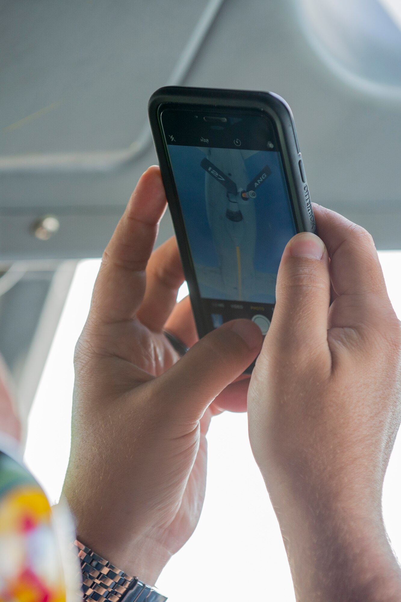 A member of the Leadership Central Delaware program takes a photo during a mock air refueling June 13, 2017, on Dover Air Force Base, Del. The KC-135 Stratotanker, from the Pittsburgh Air National Guard, simulated mid-air refueling for program participants. (U.S. Air Force photo by Staff Sgt. Jared Duhon)
