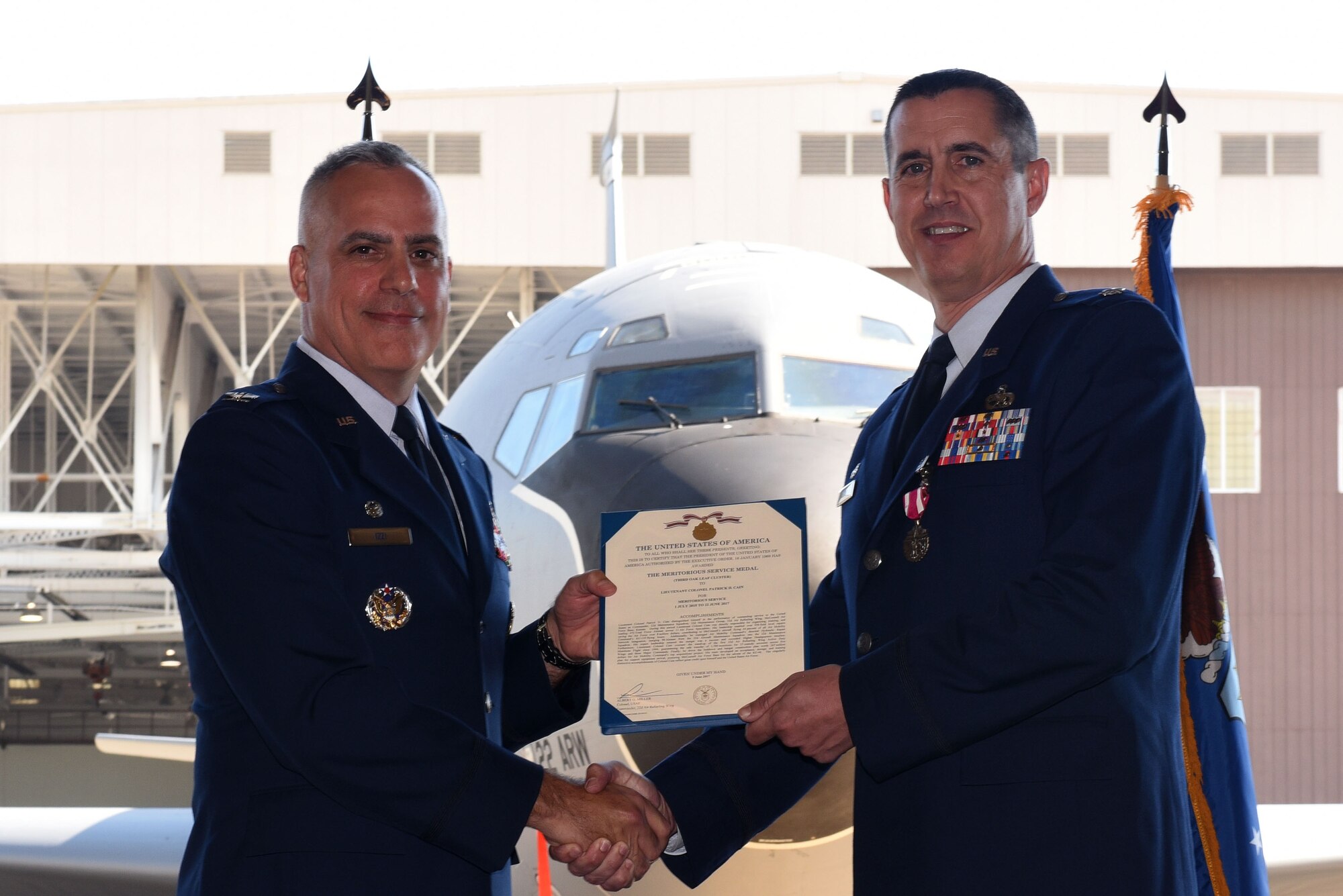 Col. Grant Izzi, 22nd Maintenance Group commander, presents the Meritorious Service Medal to Lt. Col. Patrick D. Cain, 22nd Maintenance Squadron commander June 22, 2017, at McConnell Air Force Base, Kan. The Meritorious Service Medal is awarded to members of the U.S. Armed Forces who distinguished themselves by outstanding non-combat meritorious achievement or service to the U.S. subsequent to Jan. 16, 1969. (U.S. Air Force photo/ Airman 1st Class Alan Ricker)