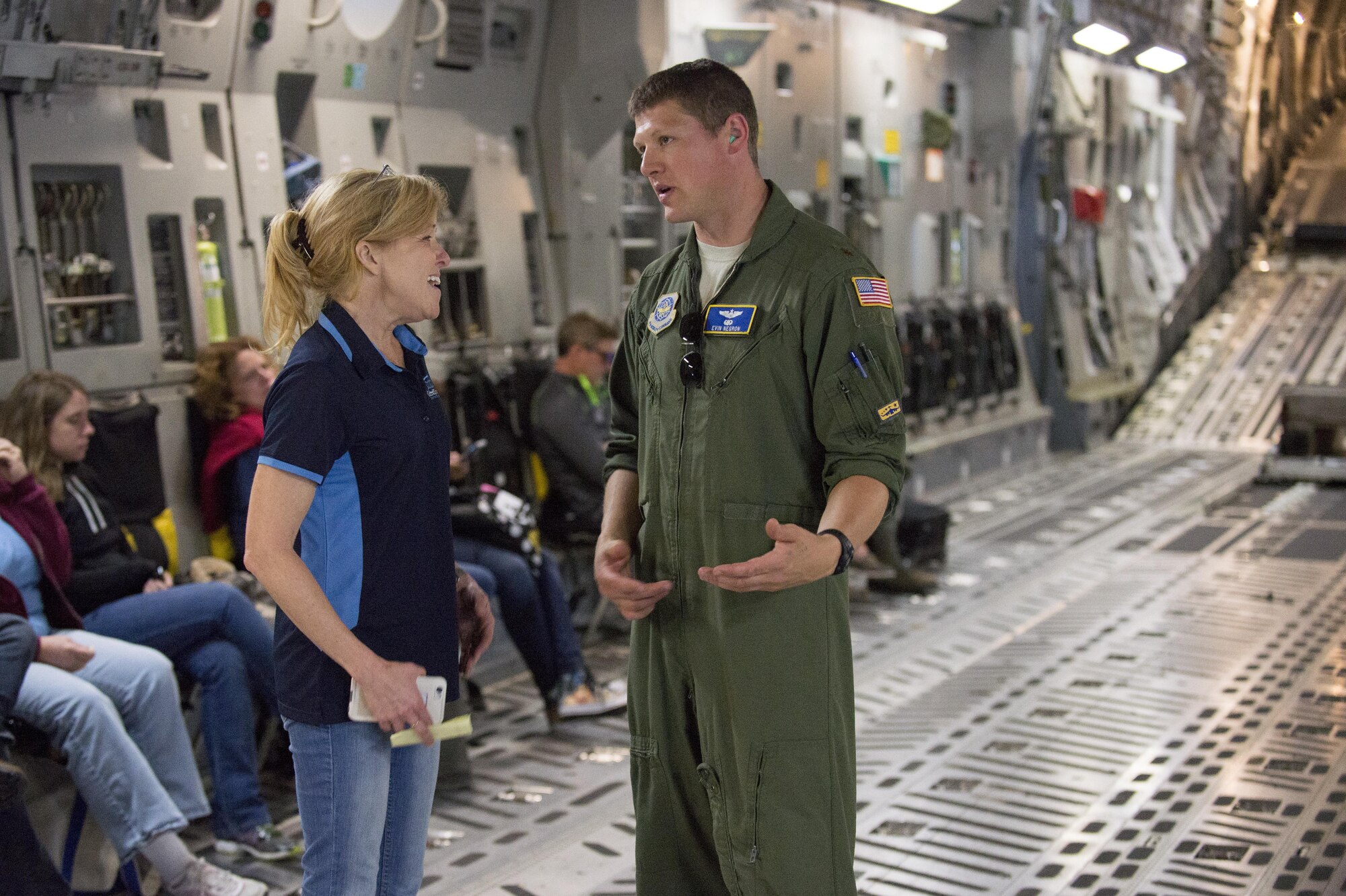 Teresa Connor, Central Chamber of Commerce event coordinator, talks with Maj. Evin Negron, 3d Airlift Squadron C-17 Globemaster III pilot, during a flight June 13, 2017, on Dover Air Force Base, Del. The flight was designed to showcase Air Force capabilities to members of the Leadership Central Delaware program. (U.S. Air Force photo by Staff Sgt. Jared Duhon)