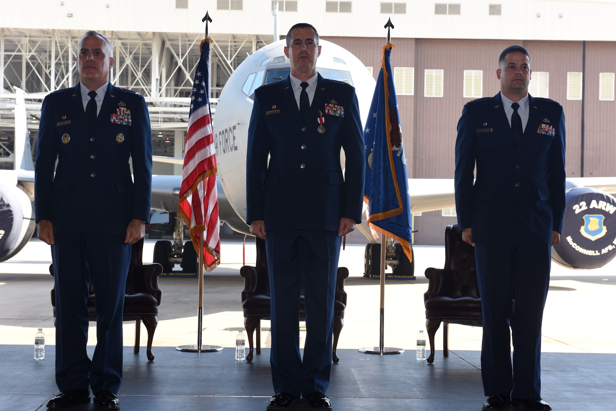 Col. Grant Izzi, 22nd Maintenance Group commander, Lt. Col. Patrick Cain, 22nd Maintenance Squadron commander, and Maj. Joshua D. Downing, 22nd Aircraft Maintenance Squadron Maintenance Operations Officer stand at attention June 22, 2017, at McConnell Air Force Base, Kan. Izzi, Cain, and Downing stood to prepare for the passing of the guidon for the change of command ceremony. (U.S. Air Force photo/ Airman 1st Class Alan Ricker)