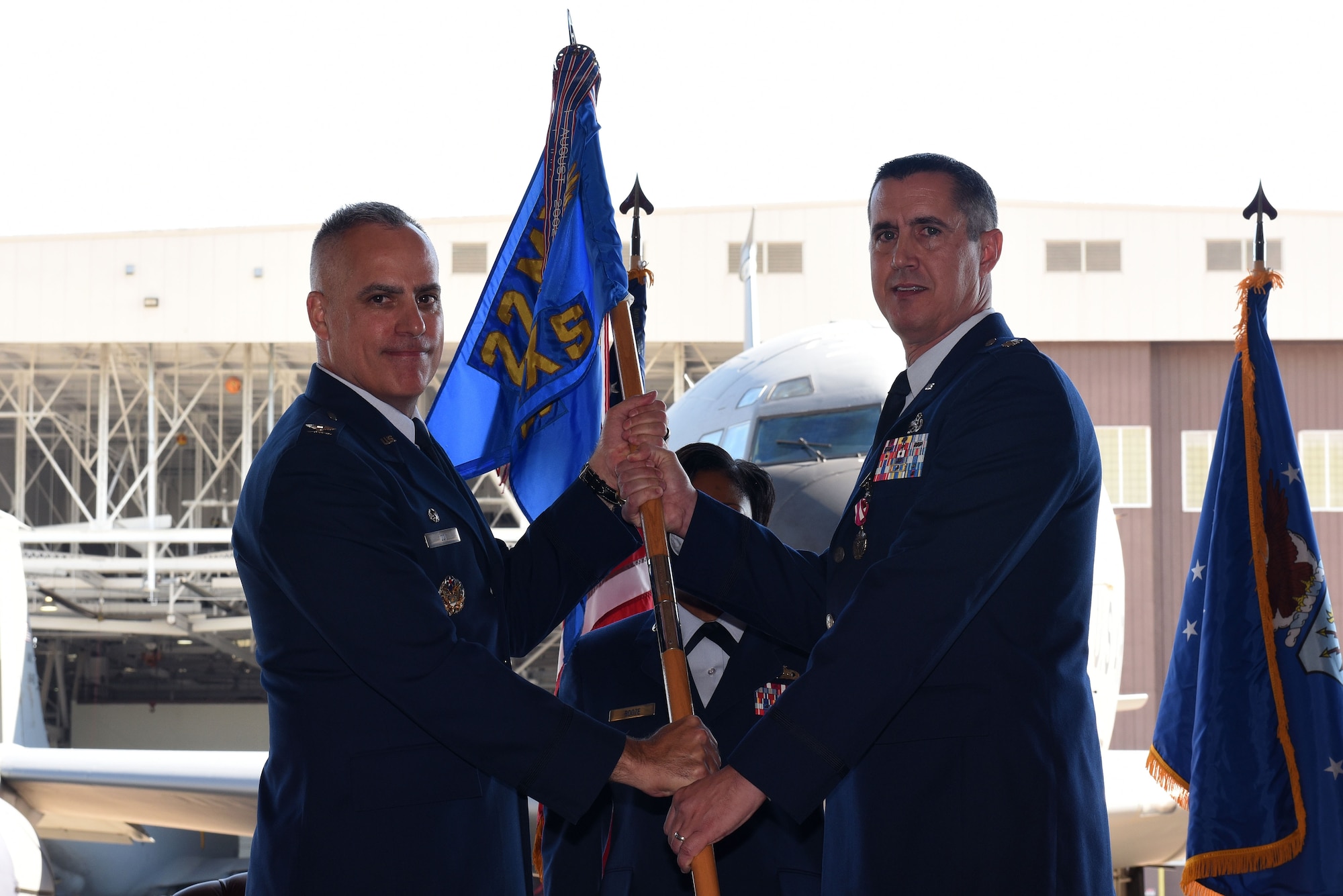 Col. Grant Izzi, 22nd Maintenance Group commander, passes the guidon to Lt. Col. Patrick Cain, 22nd Maintenance Squadron commander during a change of command ceremony June 22, 2017, at McConnell Air Force Base, Kan. Cain relinquished command to Maj. Joshua Downing. (U.S. Air Force photo/ Airman 1st Class Alan Ricker)