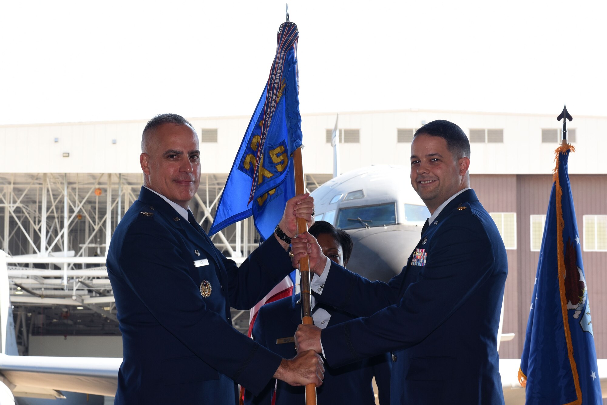 Col. Grant Izzi, 22nd Maintenance Group commander, passes the guidon to Maj. Joshua Downing, 22nd Maintenance Squadron commander during a change of command ceremony June 22, 2017, at McConnell Air Force Base, Kan. Downing assumed command during the ceremony. (U.S. Air Force photo/ Airman 1st Class Alan Ricker)