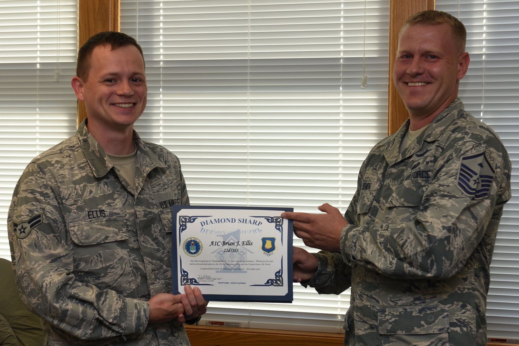Master Sgt. Robert Semen, 22nd Operations Support Squadron first sergeant, presents the Diamond Sharp Award to Airman 1st Class Brian Ellis, 22nd OSS airfield systems technician June 22, 2017, at McConnell Air Force Base, Kan. The Diamond Sharp Award is presented to Airmen who excel in all areas of their job performance and personal appearance. (U.S. Air Force photo/Airman 1st Class Alan Ricker)