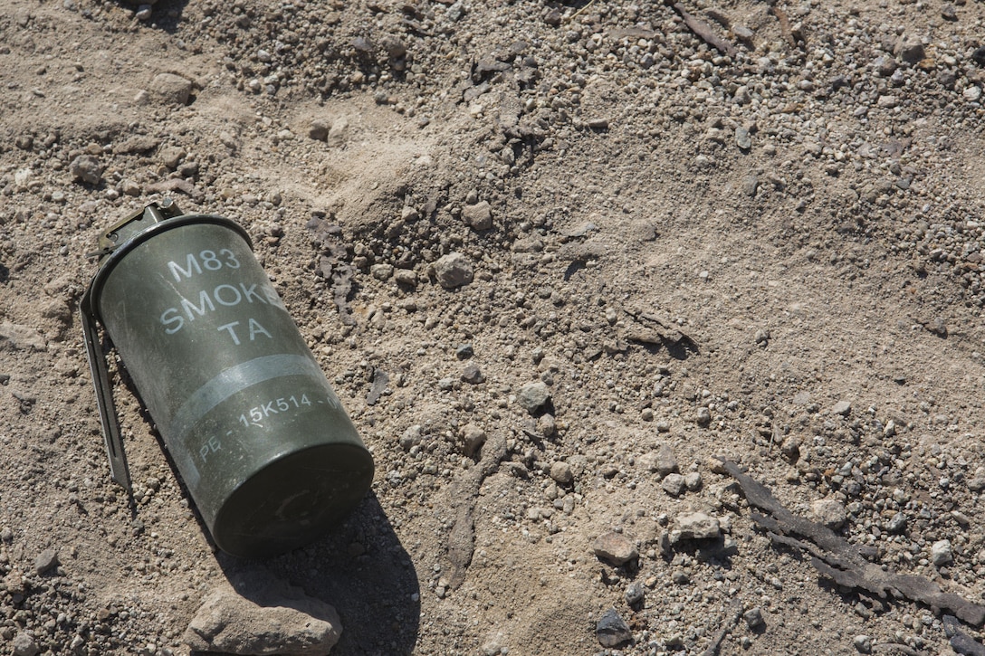 An M83 smoke grenade lies in the gravel, after being used by Marines with Golf Company, 2nd Battalion, 25th Marines, 4th Marine Division, Marine Forces Reserve, during range 400 as part of Integrated Training Exercise 4-17 at Camp Wilson, Twentynine Palms, California on June 18, 2017. ITX 4-17 is live-fire and maneuver combined arms exercise designed to train battalion and squadron-sized units in the tactics, techniques, and procedures required to provide a sustainable and ready operational reserve for employment across the full spectrum of crisis and global engagement.