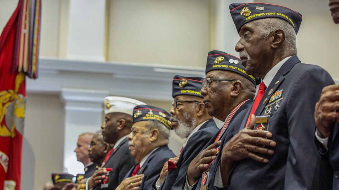 Montford Point Marines stand for the national anthem during an evening parade at Marine Barracks Washington in Washington, D.C., June 16, 2017. Montford Point Marines were the first African-Americans to serve in the Marine Corps. They were trained at Camp Montford Point in Jacksonville, N.C. Marine Corps photo by Lance Cpl. Paul A. Ochoa